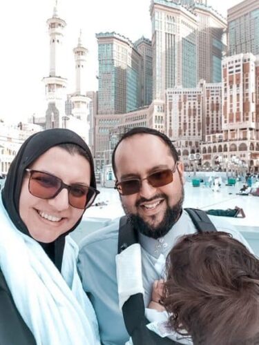 Holding our daughter while on Umrah in the carrier
